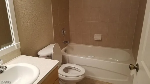 a bathroom with a sink a toilet and a bathtub