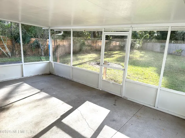 a view of an empty room with windows