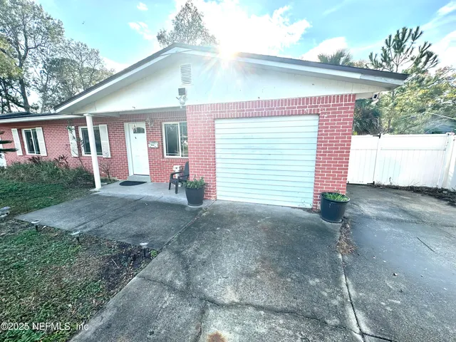 a view of a house with a yard and garage