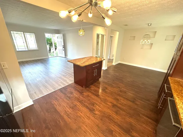 a spacious bathroom with a granite countertop sink a mirror and shower