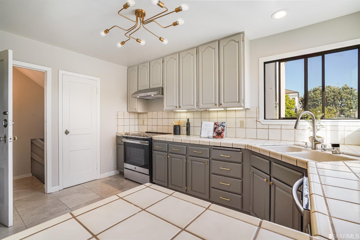 96 Middlefield Drive San Francisco, CA 94132 - Photo 17 of 46 a kitchen with a sink stove and cabinets