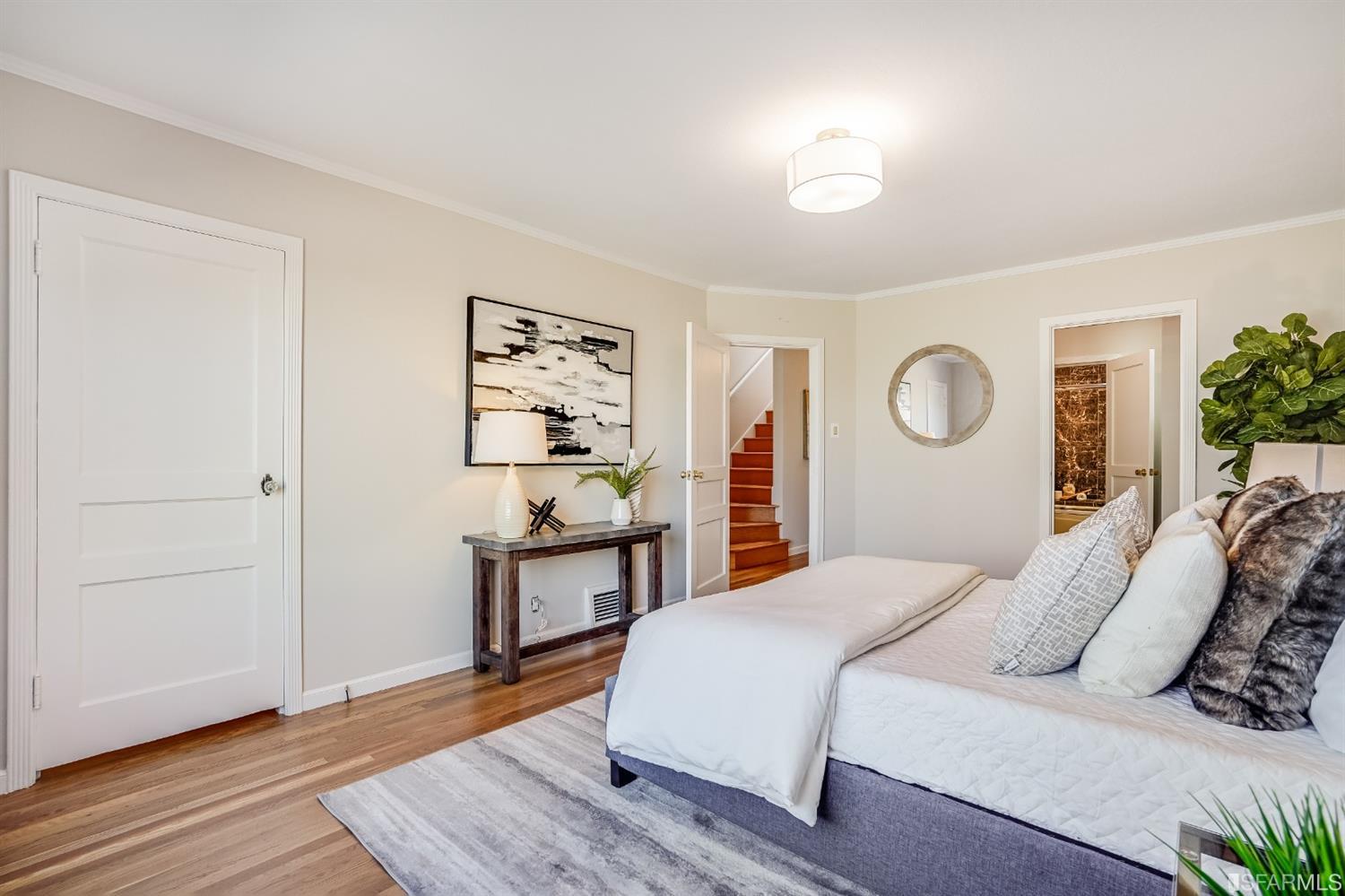 96 Middlefield Drive San Francisco, CA 94132 - Photo 23 of 46 a bedroom with a bed and wooden floor