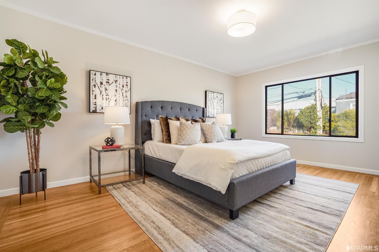 96 Middlefield Drive San Francisco, CA 94132 - Photo 24 of 46 a bedroom with a large bed and a potted plant