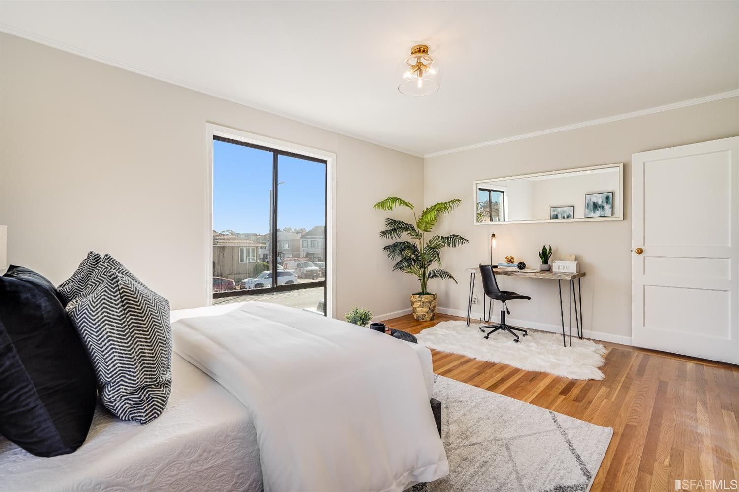 96 Middlefield Drive San Francisco, CA 94132 - Photo 31 of 46 a bedroom with a large bed and a potted plant