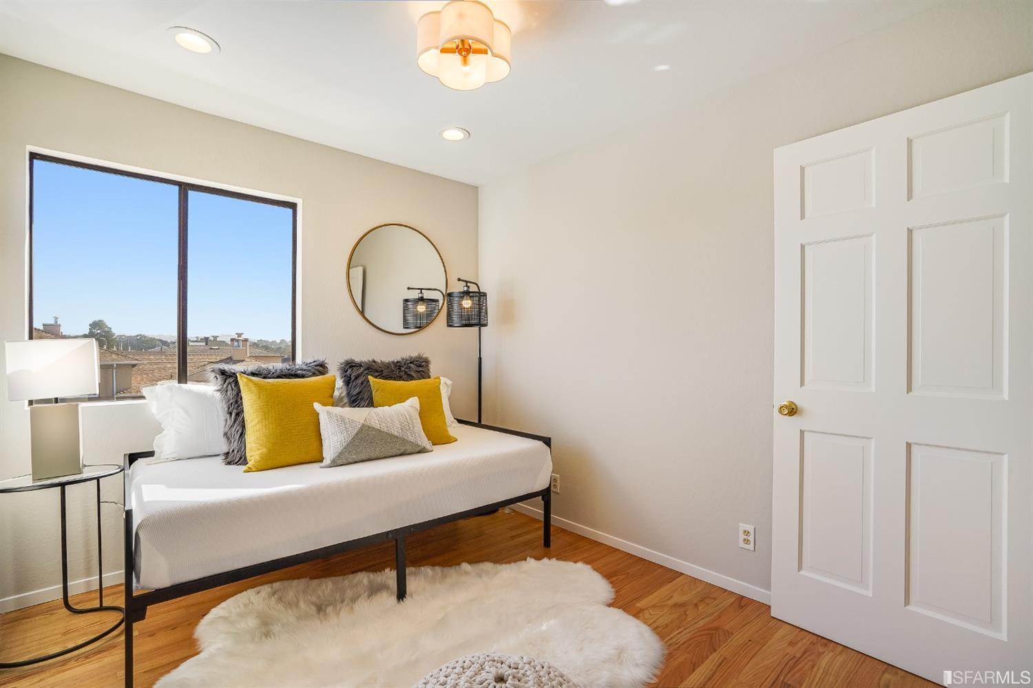 96 Middlefield Drive San Francisco, CA 94132 - Photo 32 of 46 a bedroom with a bed and a potted plant with the outer view
