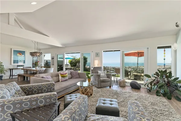 a kitchen with stainless steel appliances kitchen island granite countertop a table chairs stove and refrigerator