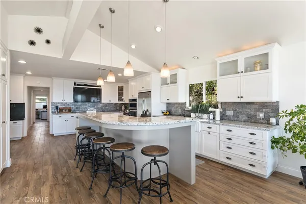 a kitchen with granite countertop white cabinets white stainless steel appliances and sink