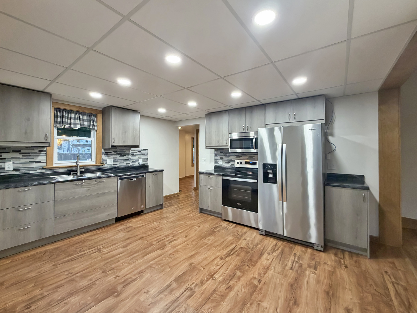 310 1st Avenue Forreston, IL 61030 - Photo 2 of 33 a kitchen with granite countertop a refrigerator and a stove top oven