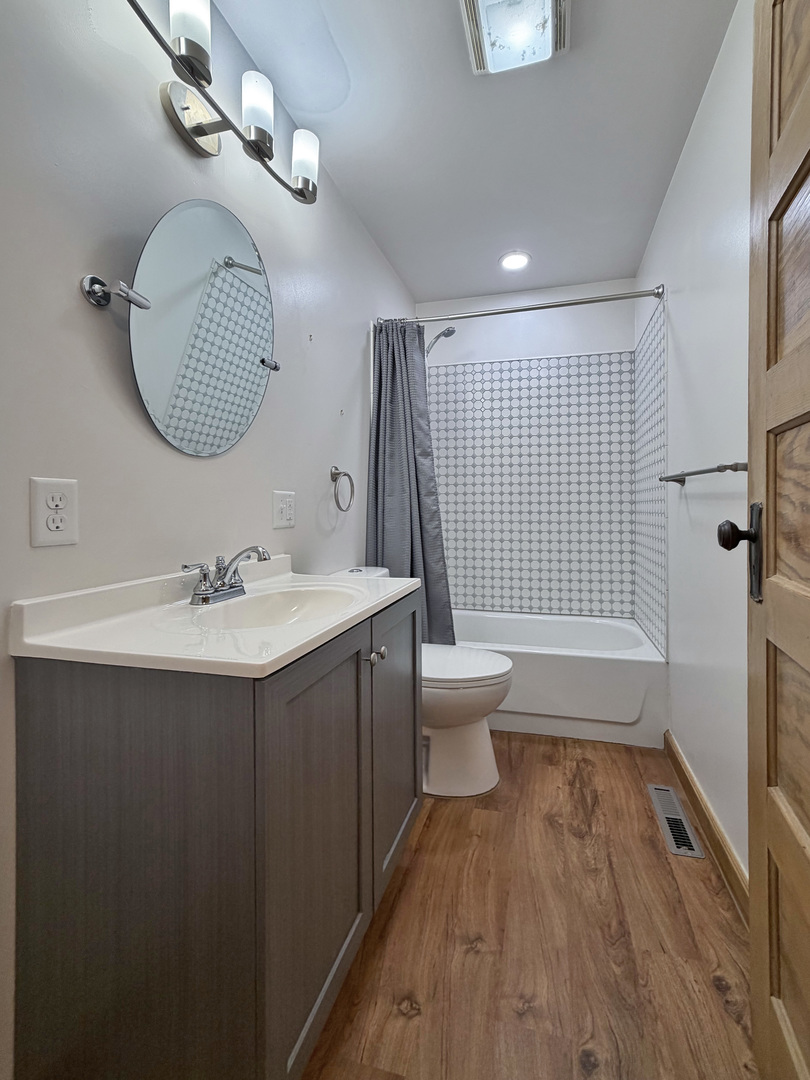 310 1st Avenue Forreston, IL 61030 - Photo 22 of 33 a bathroom with a sink toilet and shower