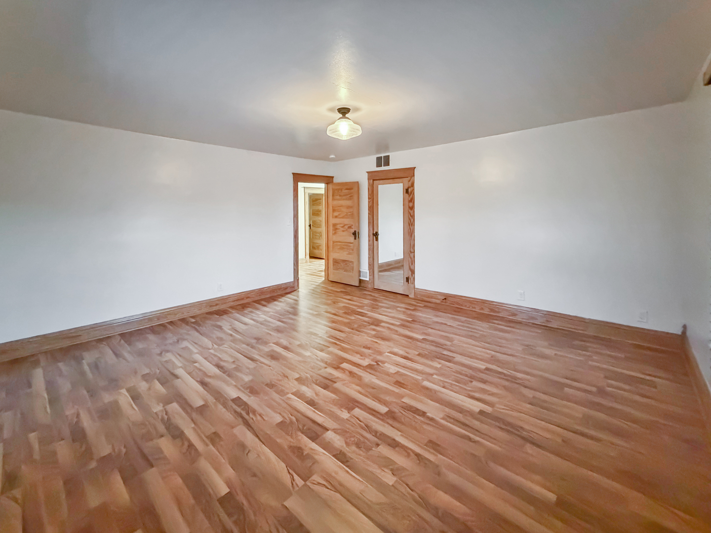 310 1st Avenue Forreston, IL 61030 - Photo 26 of 33 a view of an empty room with wooden floor and a window