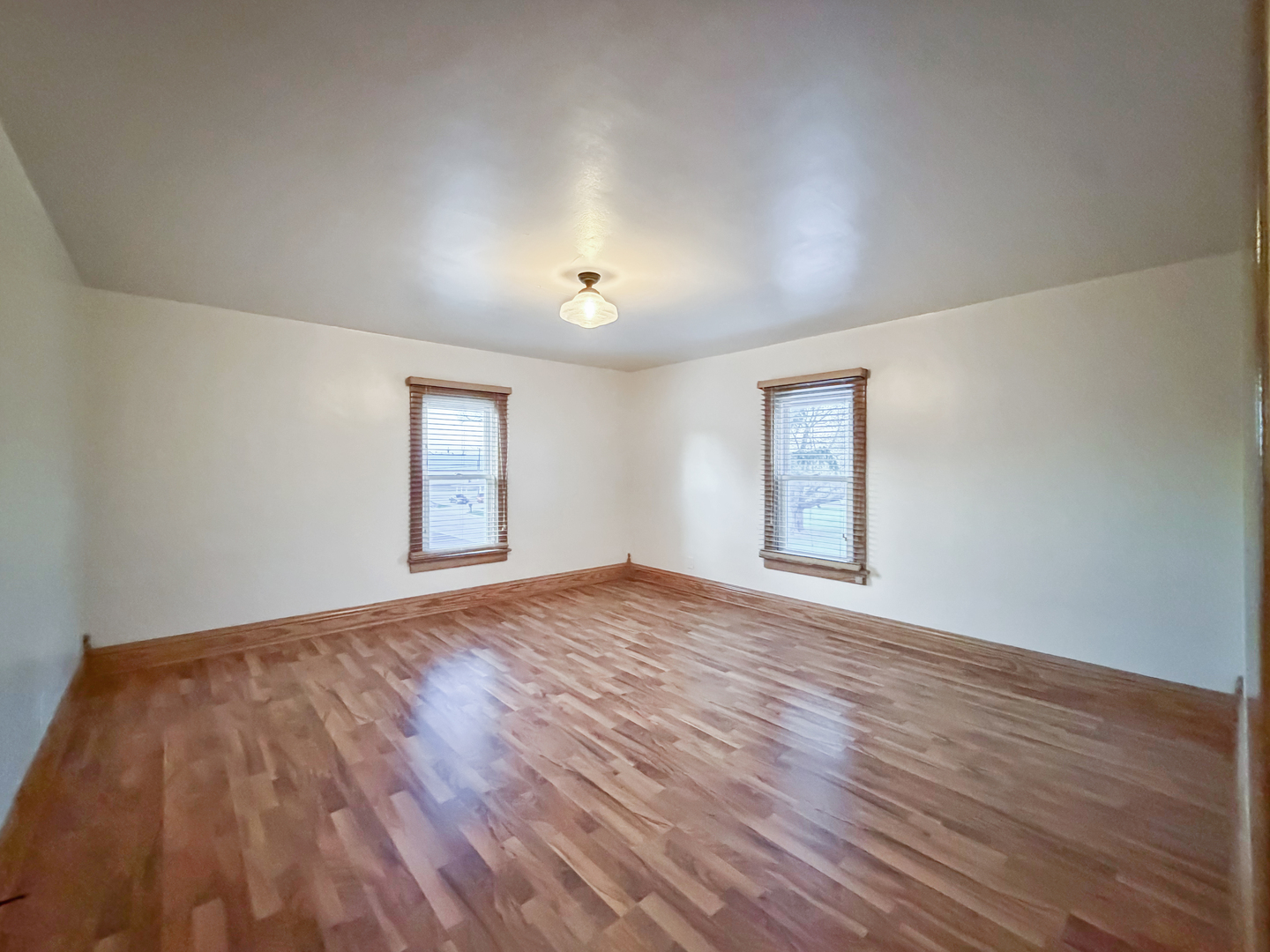 310 1st Avenue Forreston, IL 61030 - Photo 27 of 33 a view of empty room with wooden floor and fan