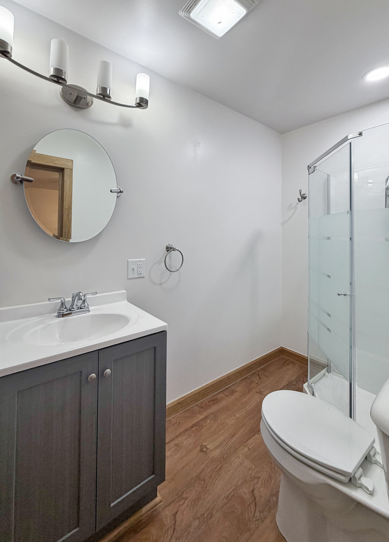 310 1st Avenue Forreston, IL 61030 - Photo 29 of 33 a bathroom with a toilet a sink a mirror and vanity