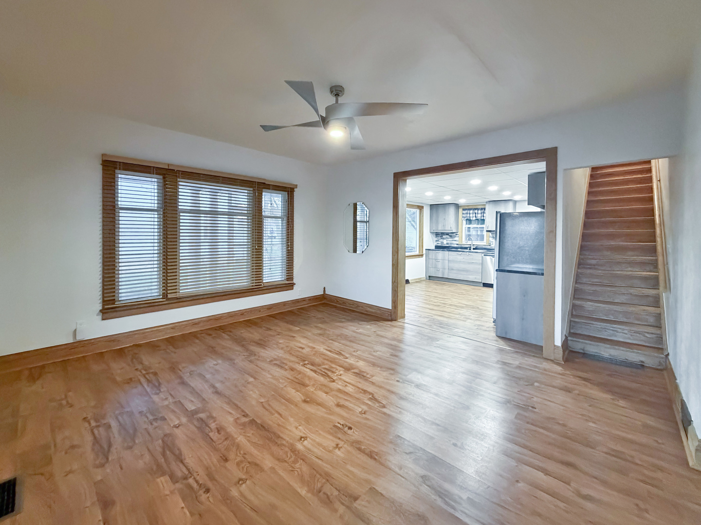 310 1st Avenue Forreston, IL 61030 - Photo 7 of 33 a view of an empty room with a window and wooden floor