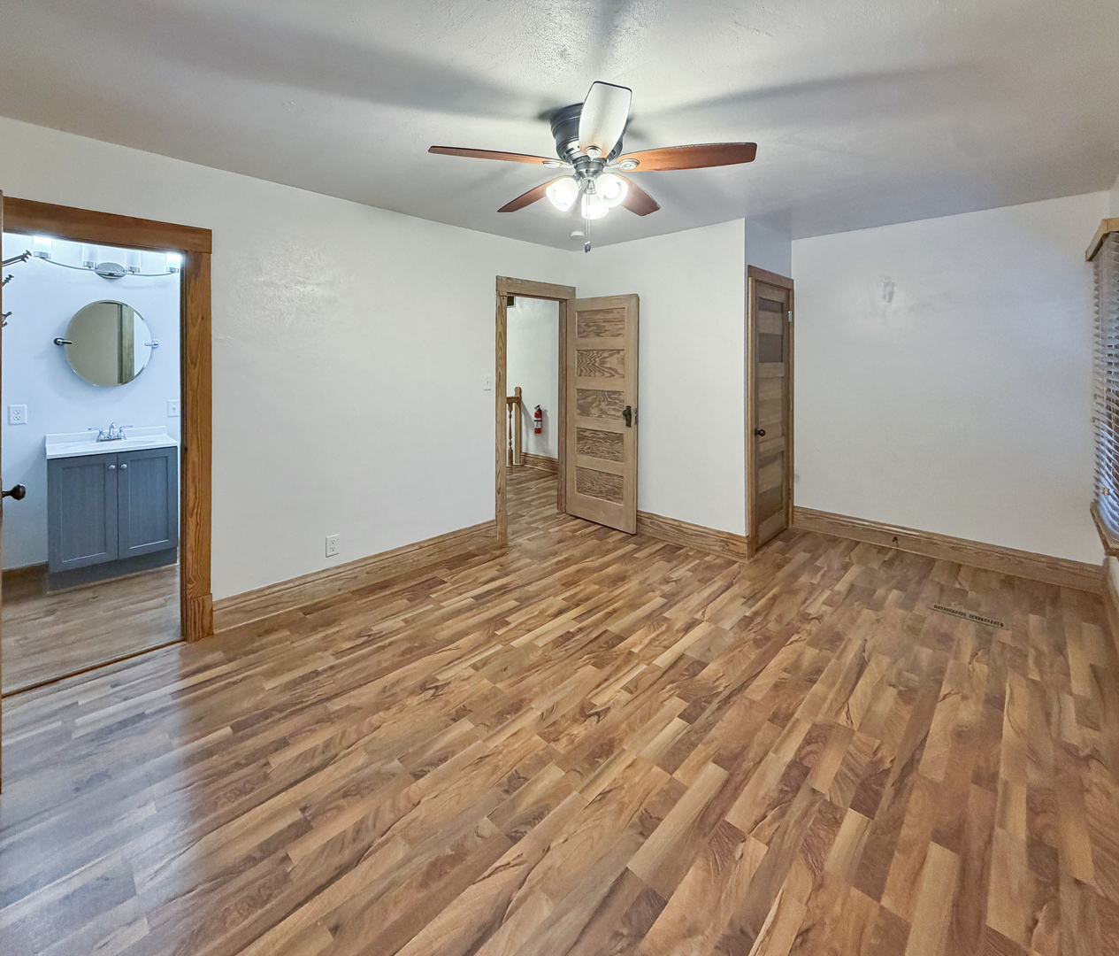 310 1st Avenue Forreston, IL 61030 - Photo 9 of 33 a view of a livingroom with wooden floor and a ceiling fan