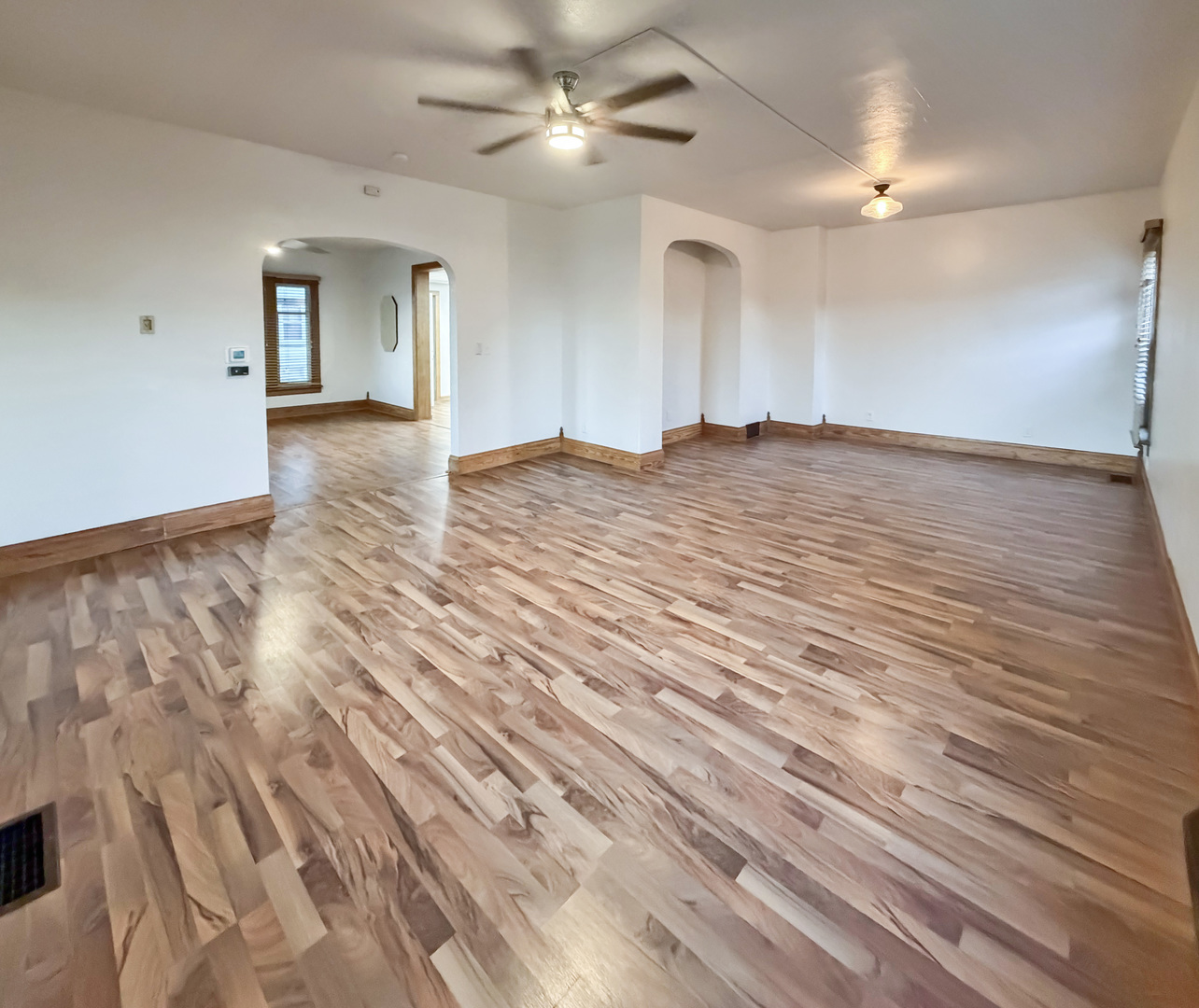 310 1st Avenue Forreston, IL 61030 - Photo 10 of 33 wooden floor in an empty room with a chandelier fan