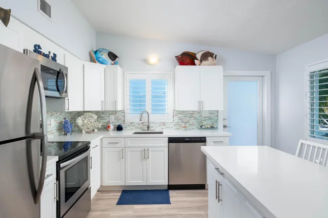 a kitchen with a sink stove and refrigerator