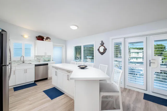 a kitchen with a sink cabinets and wooden floor