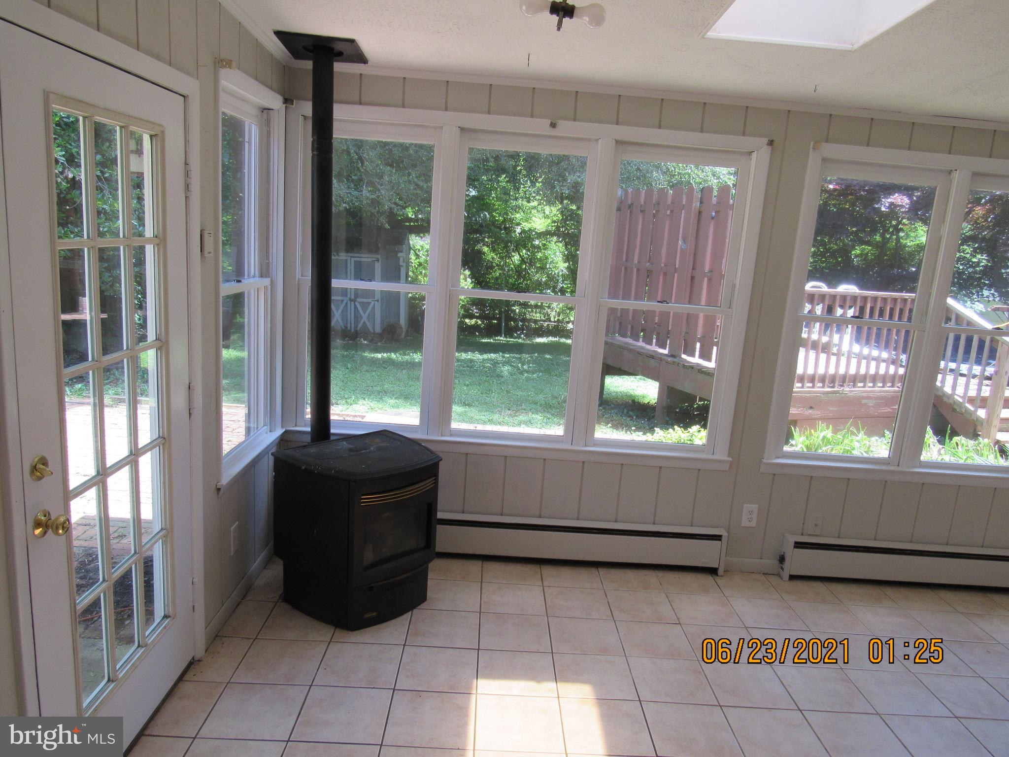 317 Red Pump Road Bel Air, MD 21014 - Photo 5 of 28 Ceramic tiled Sun Room with Pellet Stove