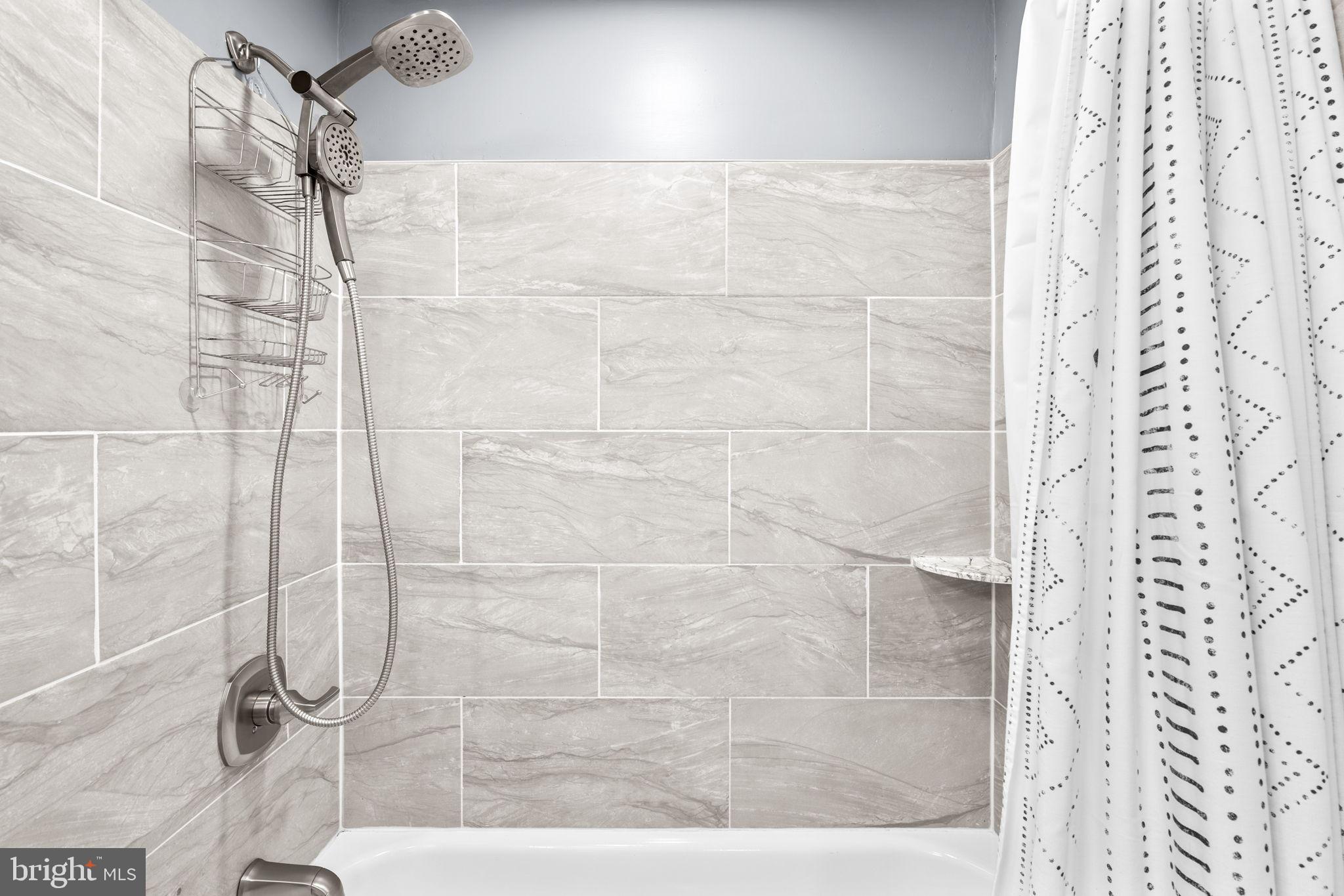 8433 Sugar Creek Lane Springfield, VA 22153 - Photo 25 of 47 Sleek modern shower with elegant tiles.