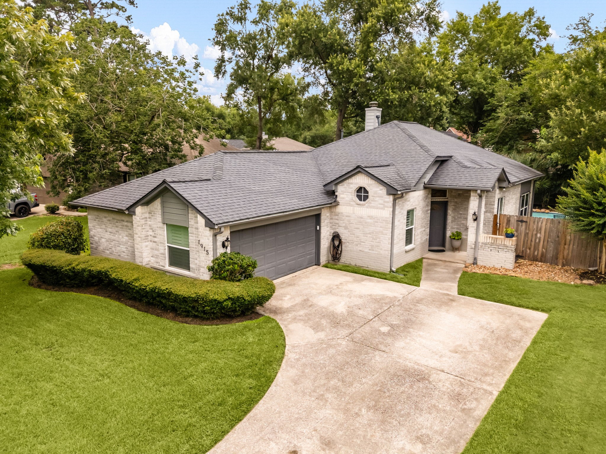 1915 Mercoal Drive Spring, TX 77386 - Photo 35 of 50 Attractive front elevation with mature landscaping, an extended driveway, and inviting curb appeal.