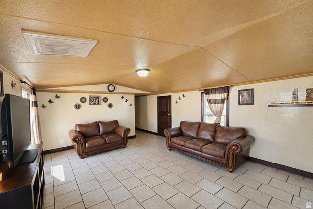 340 West 920 South, Unit 16 Provo, UT 84601 - Photo 4 of 15 Living room featuring a textured ceiling and baseboards