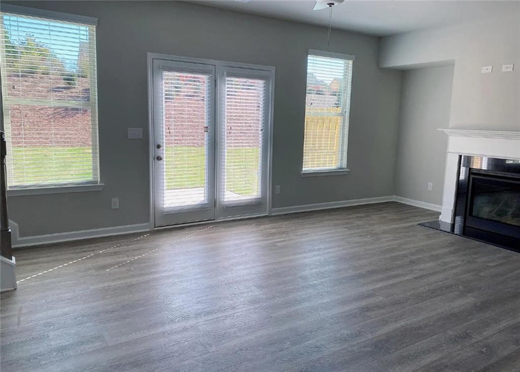 3737 Prospect Point Drive Oakwood, GA 30566 - Photo 3 of 3 a view of an empty room with wooden floor and a window
