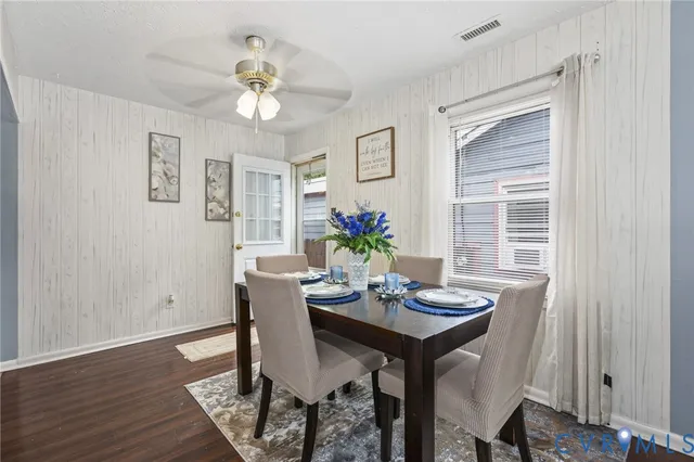 a view of a dining room with furniture a chandelier and wooden floor