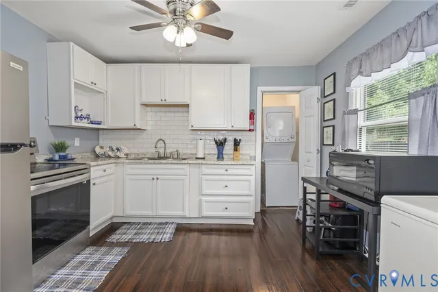 a kitchen with cabinets wooden floor and stainless steel appliances
