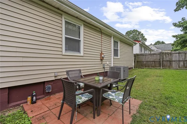 a view of backyard of house with seating space