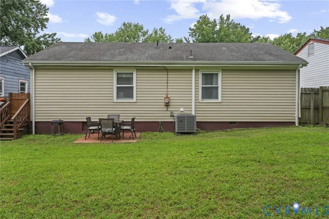 a backyard of a house with table and chairs