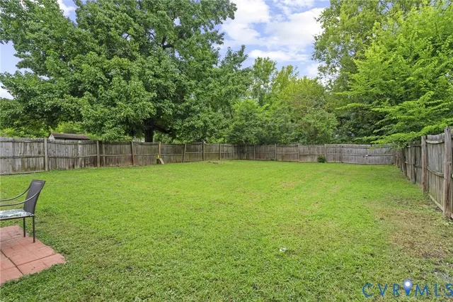 a view of yard with green space and seating
