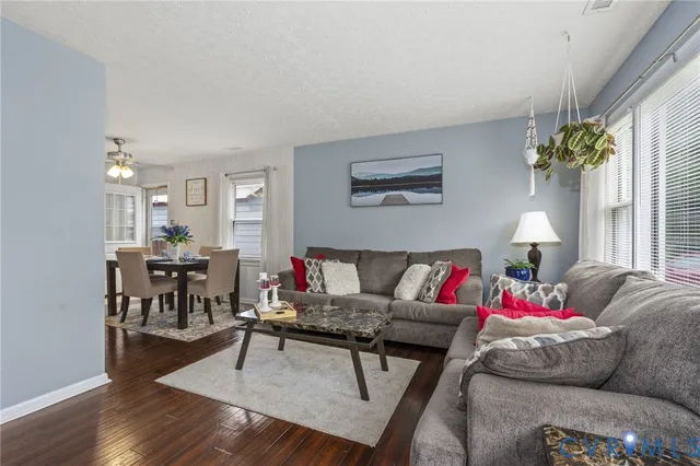 a living room with furniture and a chandelier