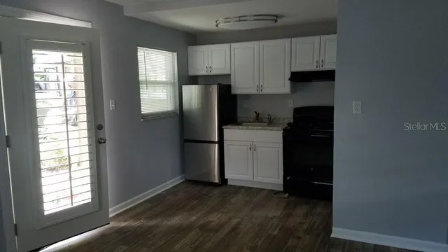 a kitchen with a refrigerator and window