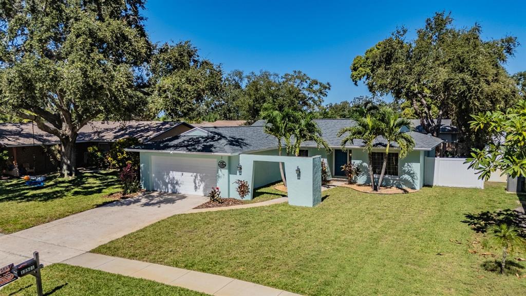 a view of a house with backyard porch and sitting area