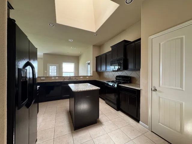 a kitchen with a refrigerator and a sink