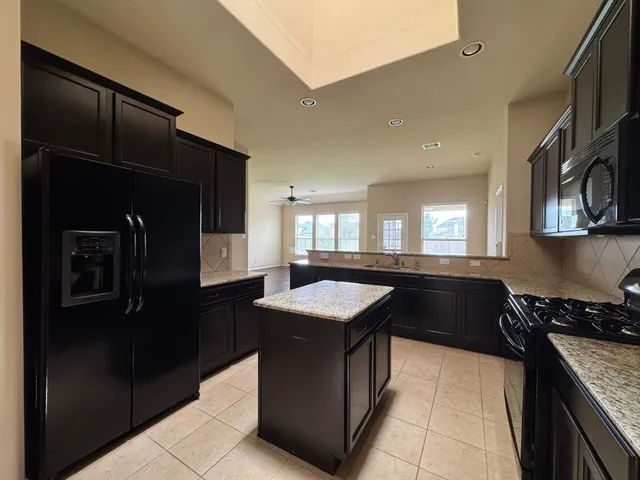 a kitchen with a sink stove and refrigerator