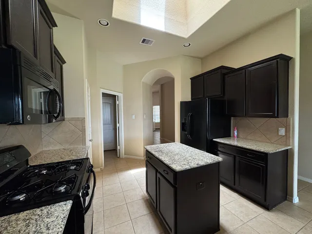 a kitchen with a stove and a refrigerator