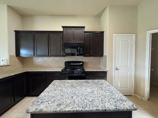 a kitchen with a sink stove and refrigerator