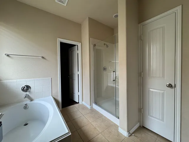 a bathroom with a bathtub and shower