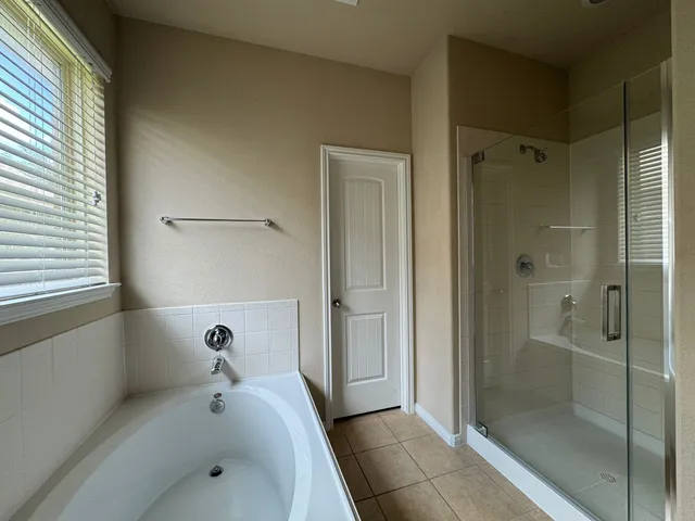 a bathroom with a tub and shower