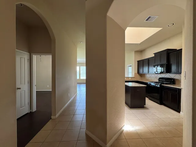 a kitchen with a refrigerator and a sink