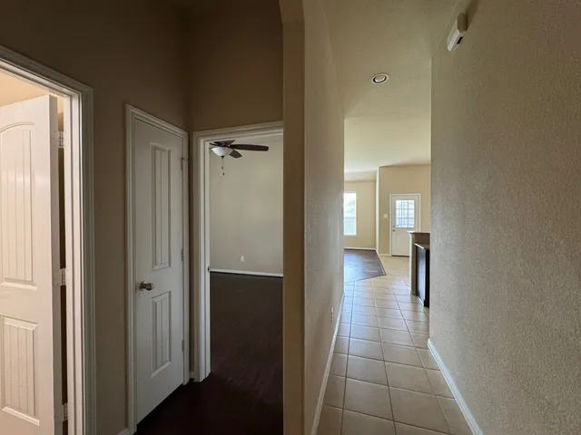 a view of a hallway with a wooden cabinets