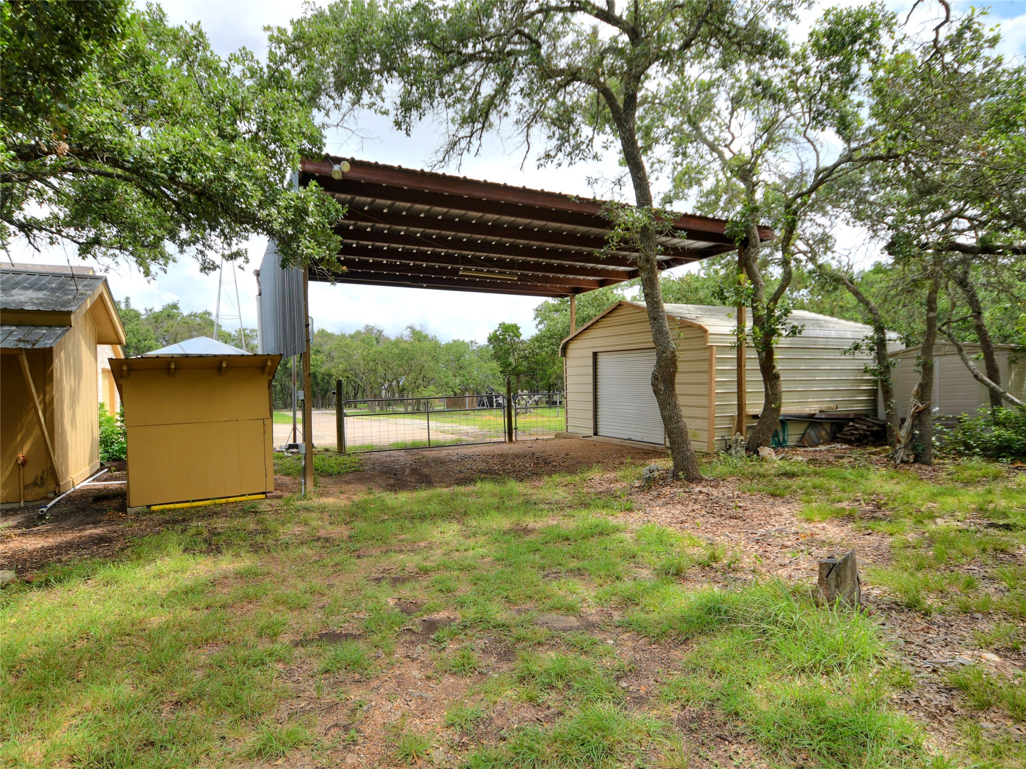 328 Fawnridge Street Georgetown, TX 78628 - Photo 33 of 33 Covered RV storage with light and electricity. 18x18 metal workshop.