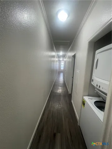 a view of a hallway with wooden floor