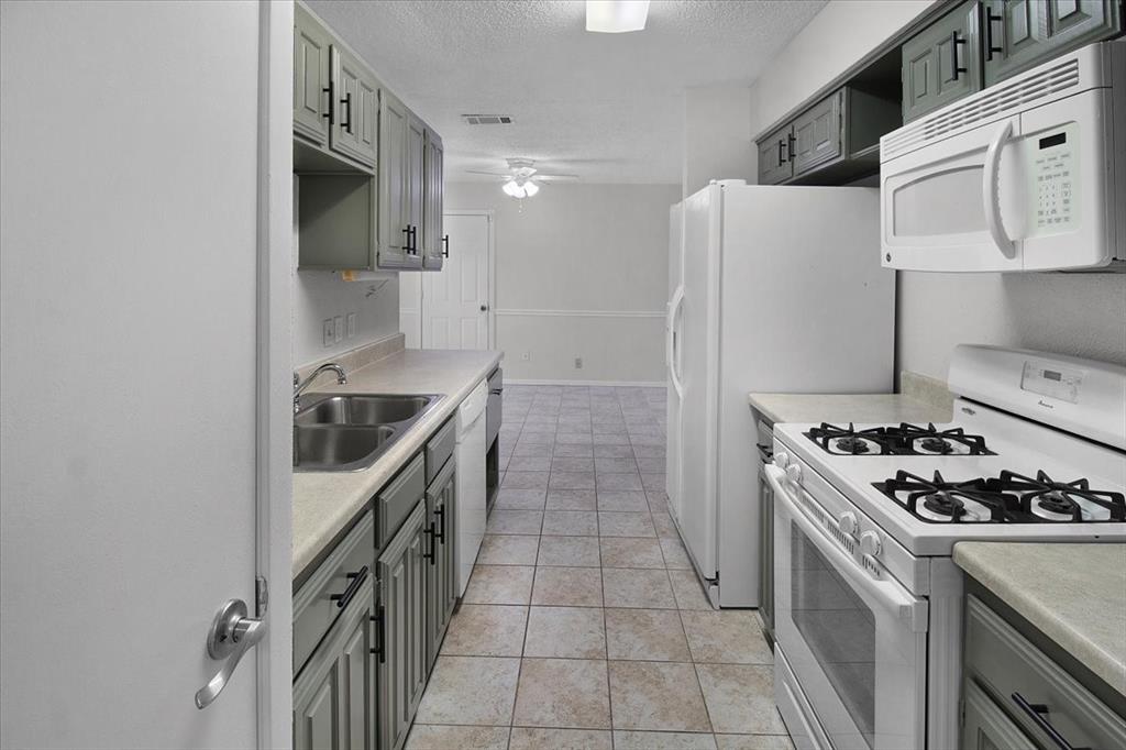 1903 Wyndemere Lane Garland, TX 75042 - Photo 13 of 28 a kitchen with granite countertop a sink and a stove