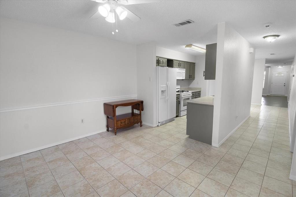 1903 Wyndemere Lane Garland, TX 75042 - Photo 20 of 28 a kitchen with stainless steel appliances a refrigerator and a stove top oven