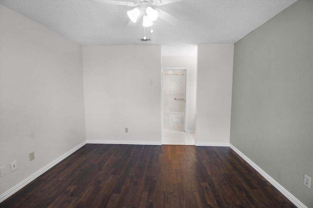 1903 Wyndemere Lane Garland, TX 75042 - Photo 22 of 28 wooden floor in an empty room with a window