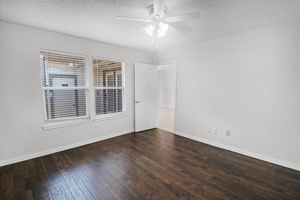 1903 Wyndemere Lane Garland, TX 75042 - Photo 23 of 28 a view of empty room with wooden floor and fan