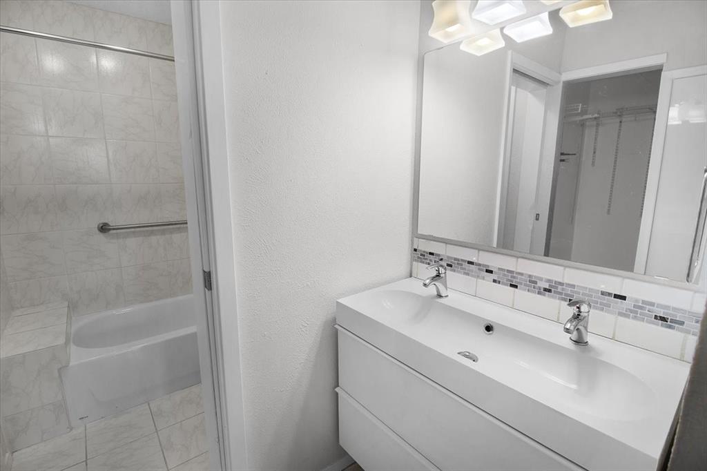 1903 Wyndemere Lane Garland, TX 75042 - Photo 24 of 28 a bathroom with a sink and a mirror