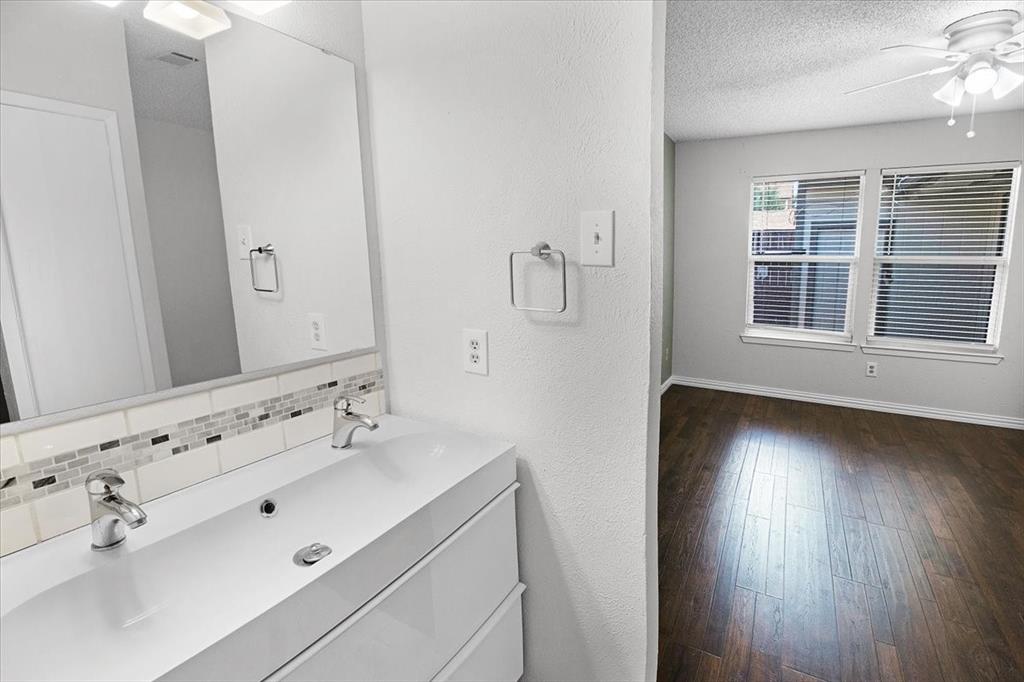 1903 Wyndemere Lane Garland, TX 75042 - Photo 26 of 28 a bathroom with a sink mirror and double vanity